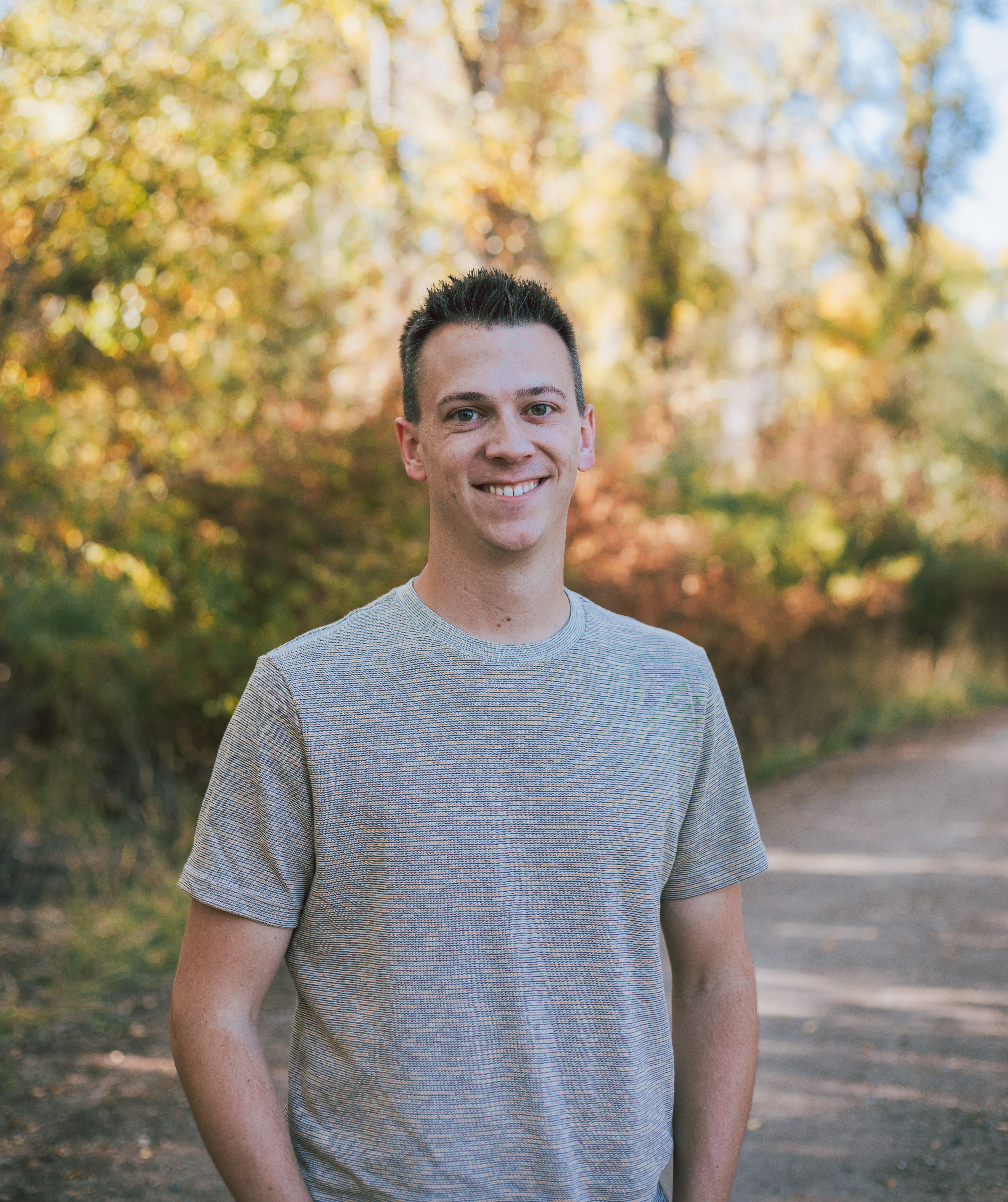 Man standing outdoors with trees in the background